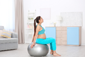 Pregnant person using an excercise ball